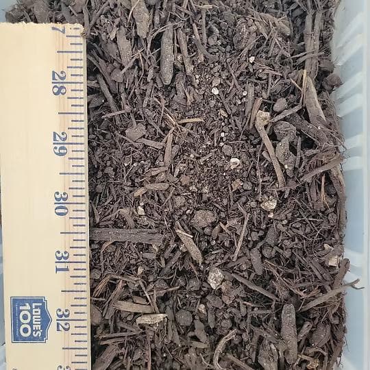 Landscape Mix soil and compost blend with a ruler for scale at Round Rock Landscape Supplies™ in Leander TX