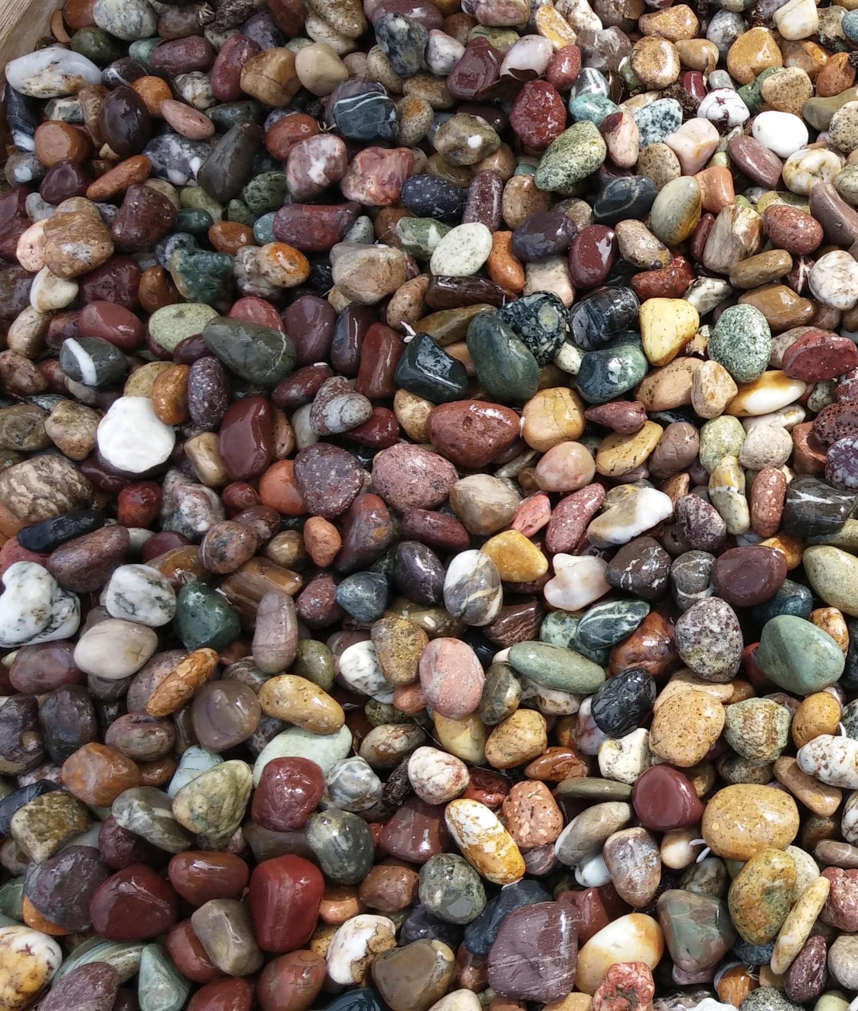 Decorative stones and rocks in deep burgundy, red, green, and earth tones